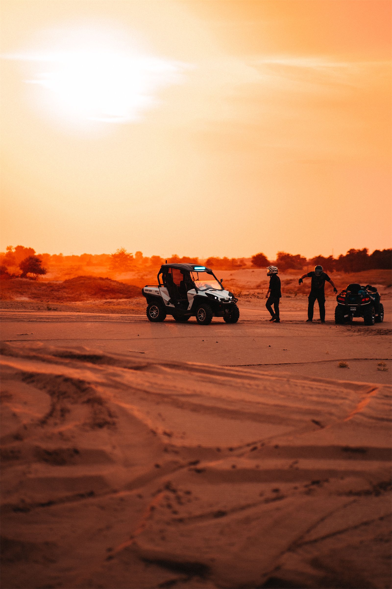 Buggy and quad bikes in the desert at sunset